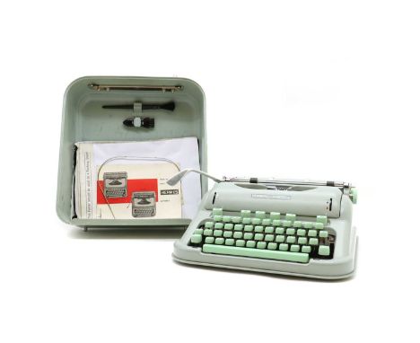 A Hermes 3000 portable typewriter,early model, in original case with instrutions, guarantee certificate, test paper and both 
