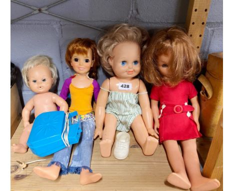 A group of four vintage doll figures.