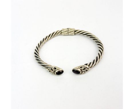 A heavy 925 garnet set sprung torque bangle.