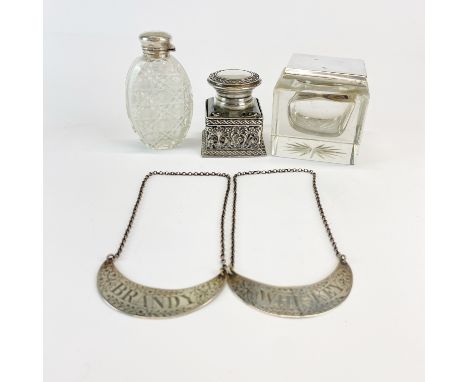 A hallmarked silver topped inkwell with a silver topped cut crystal smelling salts bottle, further white metal mounted inkwel