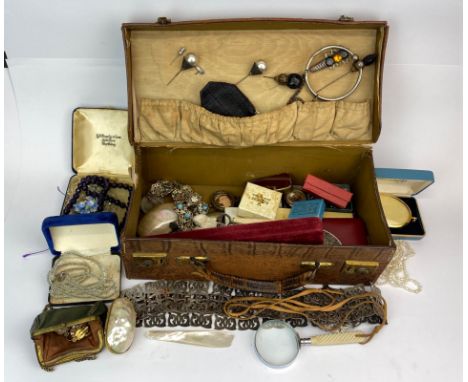 A vintage leather case and contents including hat pins and nurses belt.