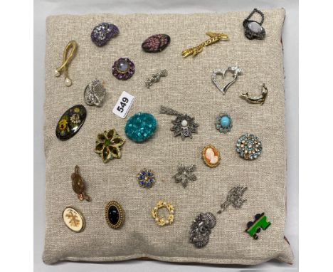 A cushion of vintage brooches.