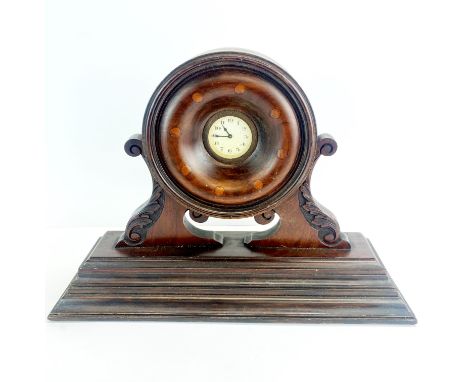An early 20th century mantle clock incorporating an aeroplane propeller boss, W. 45cm. H. 32cm.