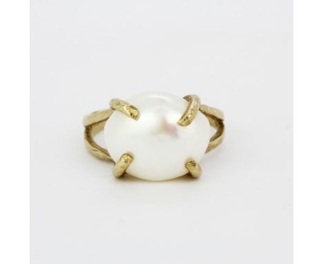 A hallmarked 9ct yellow gold ring set with a large freshwater pearl, pearl L. 1.5cm, (O.5).