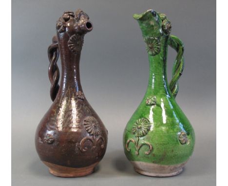 TWO CANAKKALE POTTERY EWERS Ottoman Anatolia, 19th century glazed earthenware, one brown, the other green, each of bulbous fo