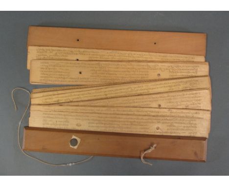 A BUDDHIST MANUSCRIPT Sri Lanka, 19th century palm leaf pot manuscript, incised and inked Sinhalese script, seven lines to th