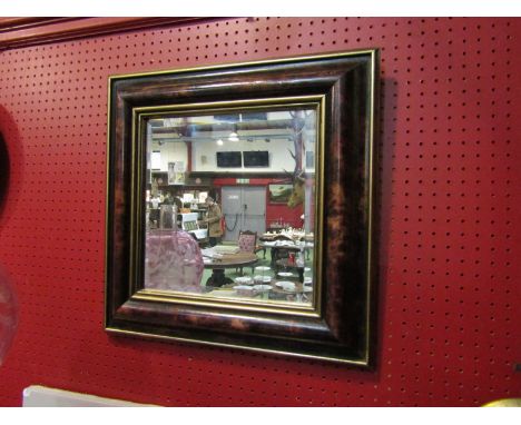 A modern square form bevelled edge mirror with cushion form frame, 48cm x 48cm