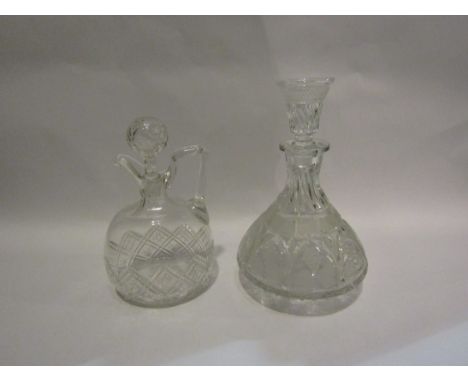 A crystal glass decanter decorated with grape and vine detail with dram measure stopper and another (2)
