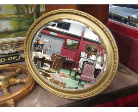 A gilt oval wall mirror, 60cm x 50cm