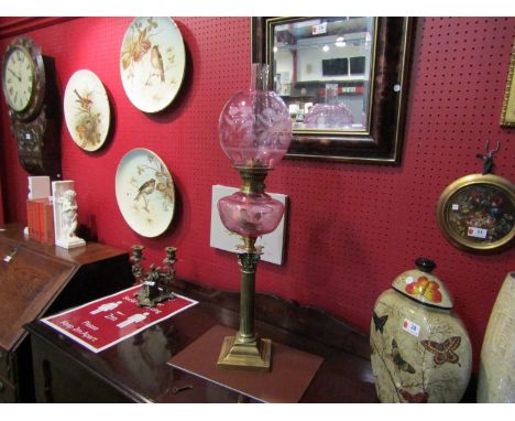 A Victorian oil lamp with pink reservoir and globular shade, 77cm tall      