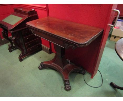 A mahogany card table with gadrooned beading over a spreading square column on quatreform base with paw feet a/f, 90cm wide x