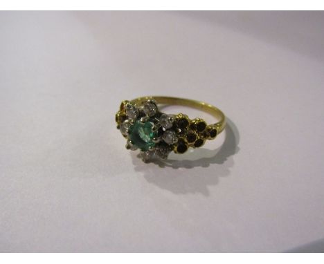 An 18ct gold emerald and diamond cluster ring. Size L/M