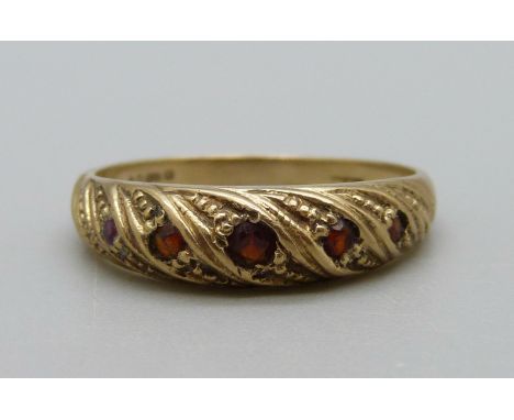 A 9ct gold and five stone garnet ring, 2.6g, P 