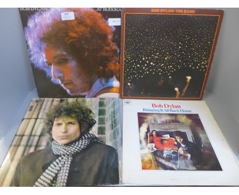 A collection of eleven Bob Dylan LP records (three gatefold) and three Woody Guthrie LP records 