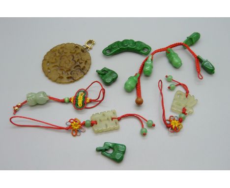 A large carved jade pendant and other carved jewellery 