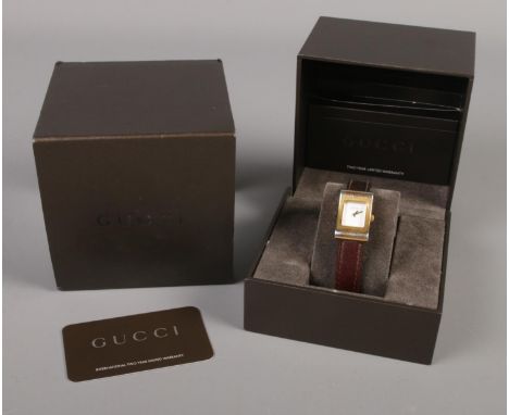 A ladies Gucci 2300L wristwatch, with box, warranty card and manual.  Wear to gilt casing, not running.