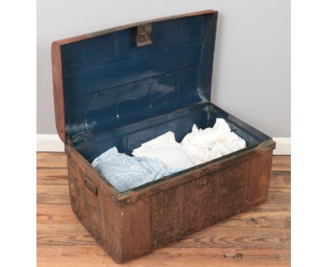 A tin trunk with contents of lace &amp; linen.  