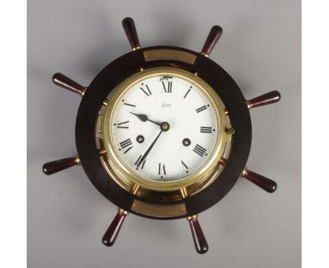 A Schatz bulk head clock in the shape of a ships wheel. With presentation plaque from Officers, US Navy, Edzell.  