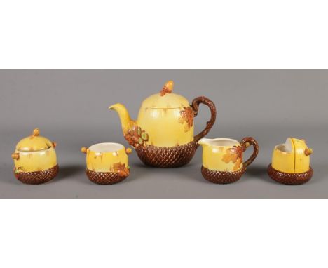 A Burleigh ware five piece oak and acorn part tea set. Includes teapot, cream jug and condiment set.  Lid to teapot has been 