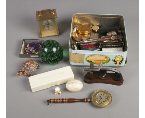A tin of collectables include Wedgwood, glass paperweight, Smiths Bed pan clock, marble egg, etc.  