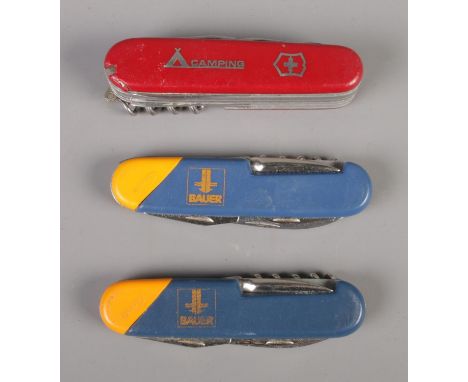 Three multi-tools including Swiss camping and Bauer examples.  
