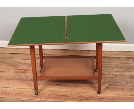 A modern fold-over card table featuring under tier and castors.  