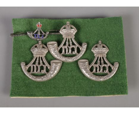 Three Durham Light Infantry cap badges along with bar brooch, all stamped Sterling to reverse. Total weight 40.5g  