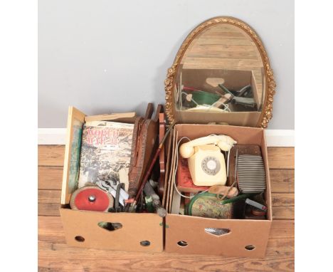 Two boxes of assorted miscellaneous. Includes bevel edged mirror, war magazines, clothes brushes, barometer and vintage tins.
