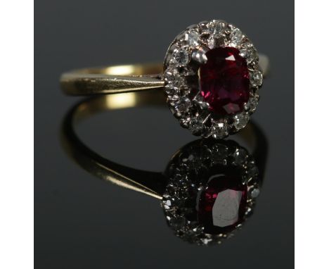 An 18ct Gold and Platinum, Ruby and Diamond cluster ring. Size K. Total weight: 3.1g.  