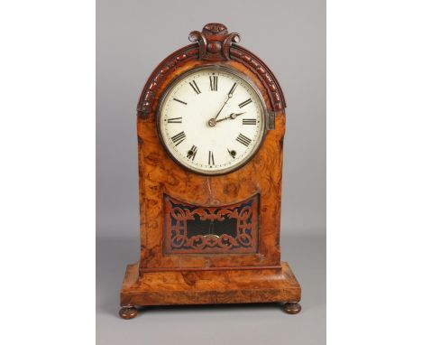 A large 19th century burr walnut mantle clock featuring roman numeral face.  Crack to wood under dial. Key and pendulum prese