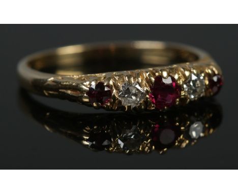 An 18ct Gold, ruby and diamond five stone ring. Size K. Total weight: 2.6g.  