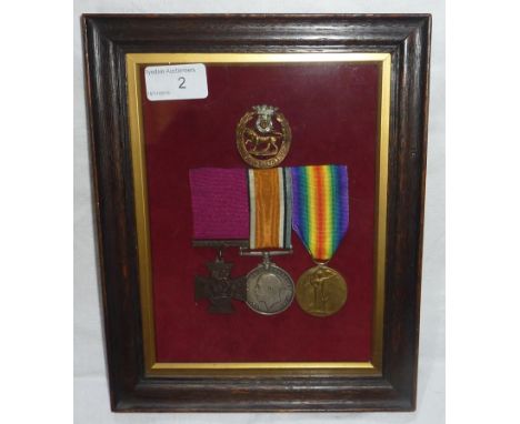 Mounted and framed display of a WWI group of medals with York's and Lancashire cap badge, the group made up from a reproducti