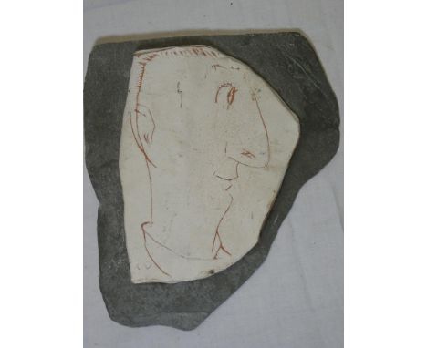 A Studio pottery plaque incised with a bust portrait of a male by Julian Dyson, 7" high on slate backing