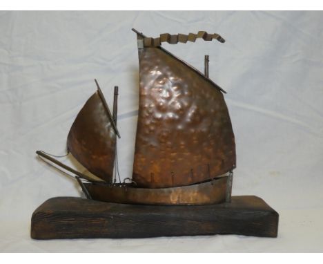 A copper model of a Newlyn fishing lugger by Mark Penrose, 13" long on wooden stand