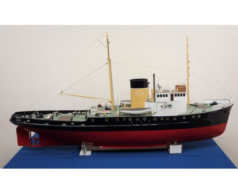 Large scale model of the motor Tug Turmoil, in OTS colours, on wooden stand, L135cm, W26cm, H66cm. Built 1945 the Turmoil was