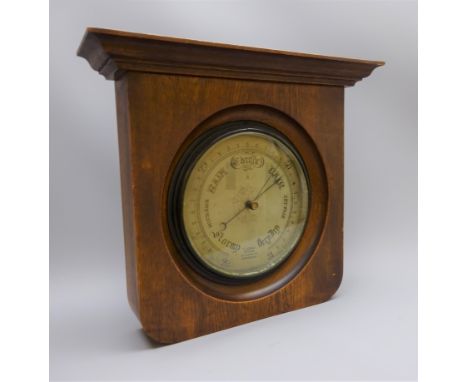 Edwardian Aneroid barometer, circular silvered dial marked F.J.Gould Optician 50 Cherry St.Birmingham, 23cm diam in oak frame