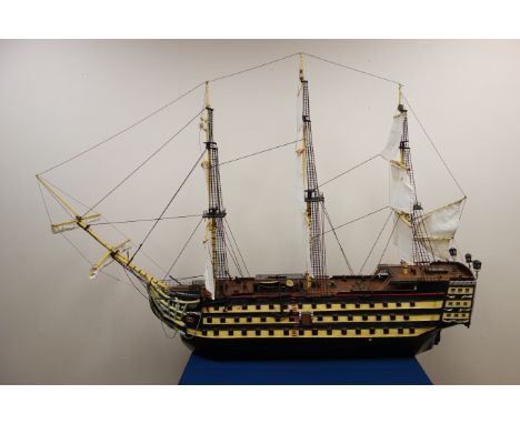 Large scale model of Nelson's Flagship HMS Victory, three masted, with sails up, painted decoration, L160cm, W28cm, H113cm 