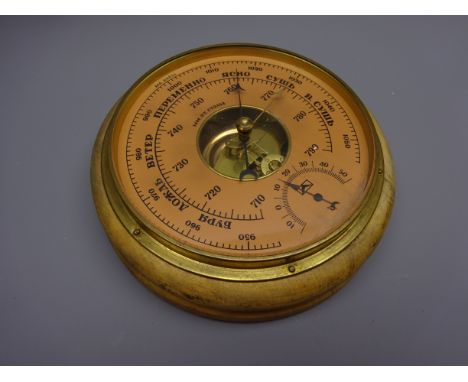Russian aneroid barometer, circular salmon dial with subsidiary temperature dial and brass bezel, stamped on back 0580231 wit