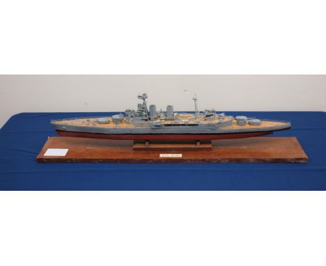 Scale built model of HMS Hood, wooden hull with plastic superstructure, guns and equipment, on stand with label 'Model built 