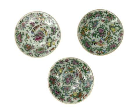 Three Chinese celadon plates decorated in the Famille Rose palette with enamelled birds, peonies and butterflies, each with s