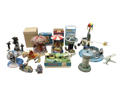 Mid 20th century and later tin plate clockwork toys, to include merry-go-rounds, spaceship carousel, walking robot, Schylling