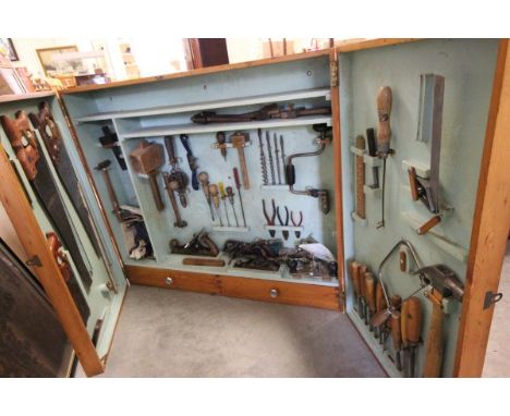Mid 20th century Wooden Hanging Tool Cabinet filled with old tools including Boxwood Handled Chiesels, Wood Planes, etc