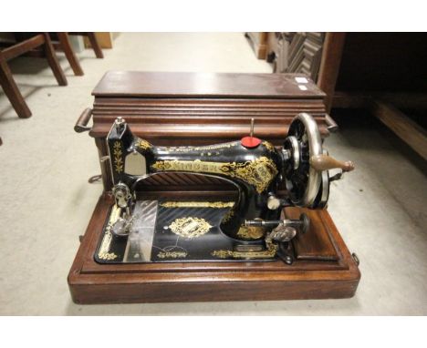 Mahogany Cased Sewing Machine and a Framed Woolwork Tapestry