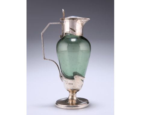 AN ART NOUVEAU SILVER-MOUNTED GREEN-GLASS CLARET JUGby William Hutton & Sons Ltd, London 1903Shouldered ovoid form, the silve