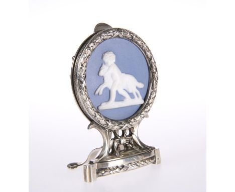 A FRENCH SILVER AND PORCELAIN MENU HOLDERby Risler & Carre, ParisCircular frame with leaf chased border, enclosing a blue jas