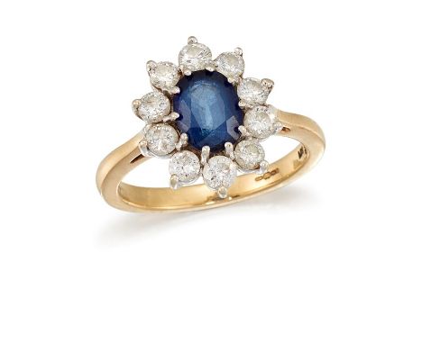 A SAPPHIRE AND DIAMOND CLUSTER RINGThe oval-cut sapphire, within a brilliant-cut diamond surround, to a polished 18 carat gol