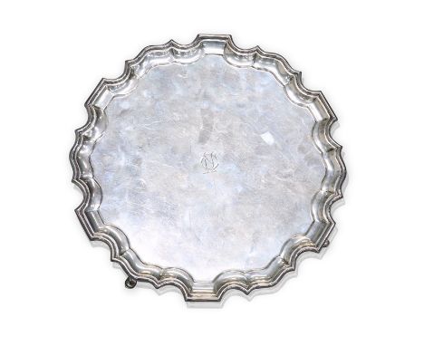 A GEORGE V SILVER SALVERby David Fullerton, London 1932Circular with piecrust edge. raised on three scroll feet, engraved wit