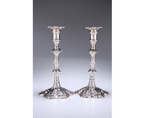 A PAIR OF GEORGE III CAST SILVER CANDLESTICKSby William Cafe, London 1763Knopped fluted baluster form columns on hexafoil bas