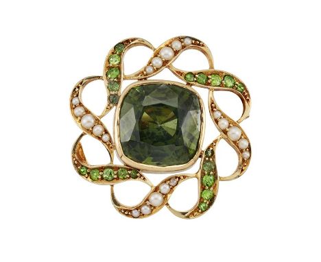 A ZIRCON, HALF PEARL AND PERIDOT BROOCHThe cushion-shaped green zircon, within a twisted openwork frame of half pearls and ci
