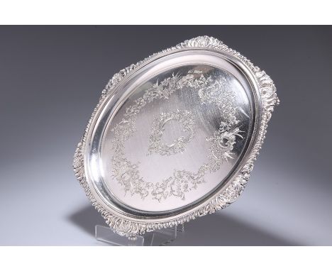 AN EDWARDIAN SILVER SALVERby Atkin Brothers, Sheffield 1905Shaped-circular form with gadrooned and scallop shell border, the 